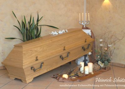 Ein Holzsarg mit Metallgriffen, umgeben von Kerzen, Blumen und einer Pflanze auf einem gefliesten Boden, schafft eine heitere Kulisse f&uuml;r die Bestattung.